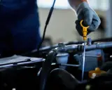 Mechanik sprawdza poziom oleju, co może pomóc wykryć nieszczelna odma objawy.