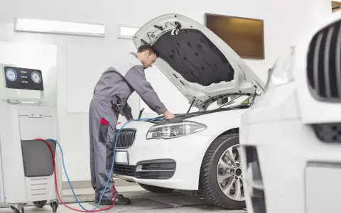 Mechanik sprawdza klimatyzację auta. Dowiedz się, ile kosztuje przegląd auta i jego serwis.