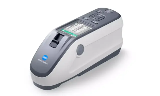 Nowoczesny spektrofotometr Konica Minolta z ekranem LCD, gotowy do precyzyjnych pomiarów koloru.