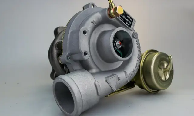 Uszkodzona turbina objawy: metalowy element z wirnikiem, zaworem upustowym i tabliczką znamionową.