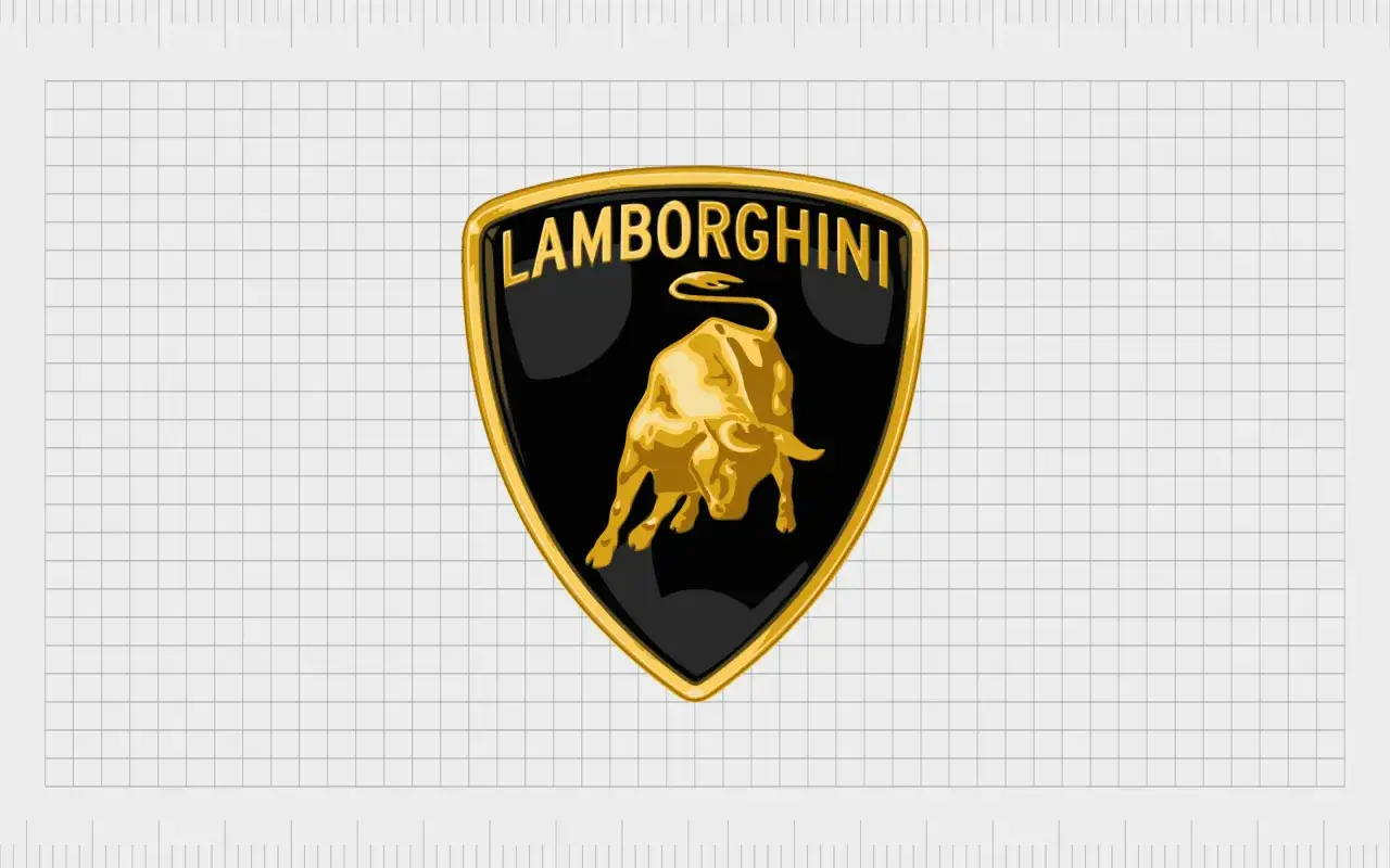 Złoty byk szarżuje na czarnym tle, otoczony złotą ramką z napisem LAMBORGHINI. Tak wygląda znaczek tej marki.